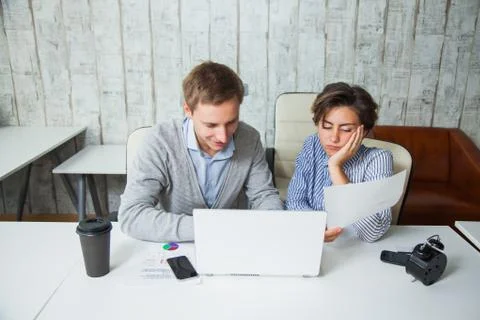 Two tired students cooperate work together office business teamwork. Fotos Stock