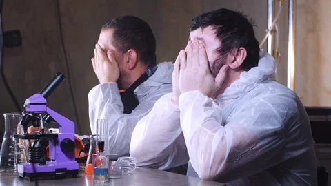 Two tired thoughtful scientists sit in laboratory. Bio lab research. DNA Science Stock-Footage 122763051