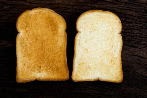 Two toast bread slice isolated on wood background Stock Photos