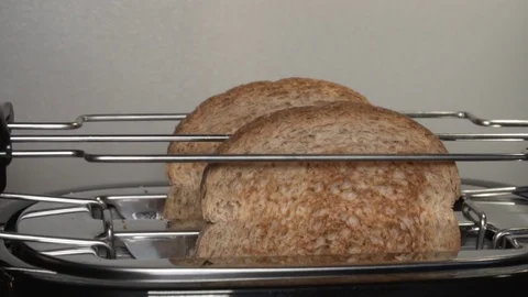 Two toasts jumping out of a toaster in slow mo Stock Footage 84238347