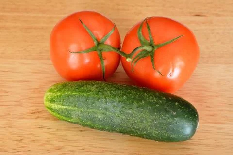 Two tomatoes and a cucumber Stock Photos