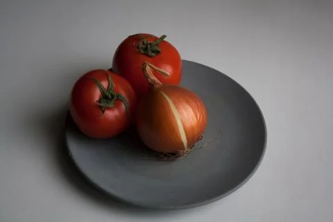 Two tomatoes and onion Stock Photos