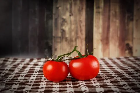 Two tomatoes on the table. Stock Photos
