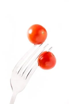 Two tomatos cherry on fork Foto stock