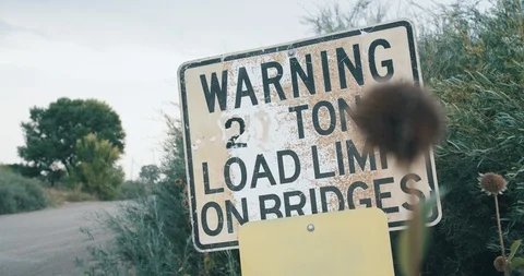 Two ton bridge load limit sign warning trucks on rural road Stock Footage 104928940