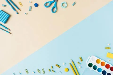 Two-tone background with scattered writing materials. Stock Photos