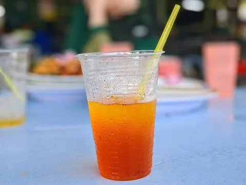 Two-tone orange drink in plastic cup Stock Photos