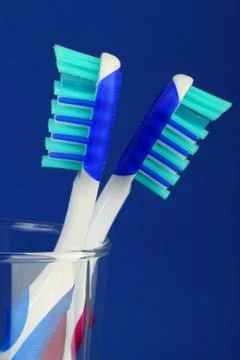 Two tooth brush in blue background Stock Photos