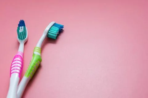 Two tooth-brushes over pink background. Dental hygiene care, copy space. Foto stock
