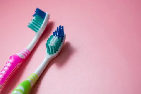 Two tooth-brushes over pink background. Dental hygiene care, copy space. Stock-Fotos