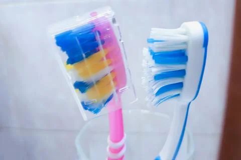 Two toothbrushes in a glass.  Stock Photos