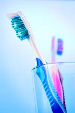 Two toothbrushes in glass Stock Photos
