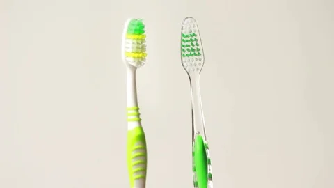 Two toothbrushes walking and greeting 스톡 동영상 76999642