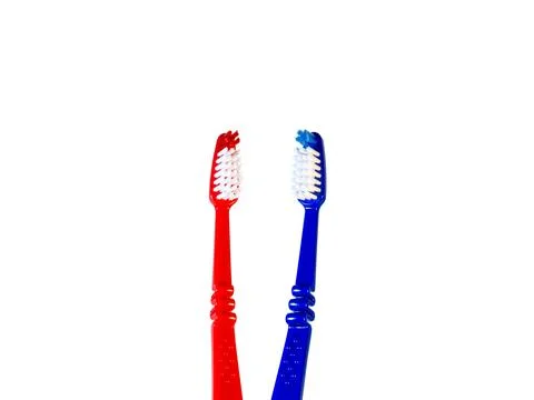 Two toothbrushes on a white background. Blue and red toothbrushes Stock Photos