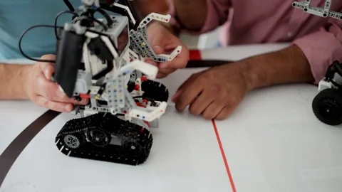 Two top sawyers working on robotic machine together 스톡 동영상 77972665