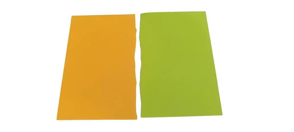 Two torn paper rectangles orange and green isolated on black Stock Photos