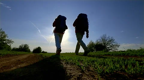 Two tourist walk in a field Stock Footage 56495166