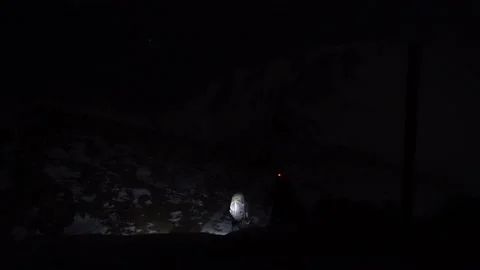 Two tourists with backpacks are walking in dark Stock Footage 230212866
