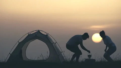 The two tourists drinking coffee at the campsite Video stock 159685694