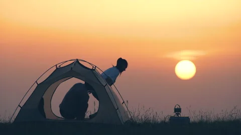 The two tourists drinking coffee at the campsite Stock Footage 159686022