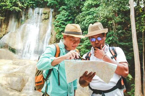 Two tourists look at the map. To study hiking trails Stock-Fotos
