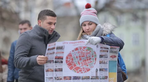 Two tourists looking for how to get it on the map Stock Footage 57525384