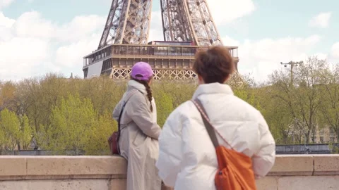 Two Tourists Photographing Eiffel Tower From Seine Bridge Wall, Medium Shot Stock Footage 340180860