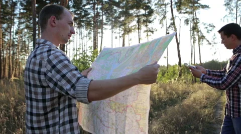 Two Tourists on a Trip, Use Map and Compass Stock Footage 67378754