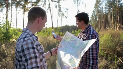 Two Tourists on a Trip, Use Map and Compass Stock Footage 68862481