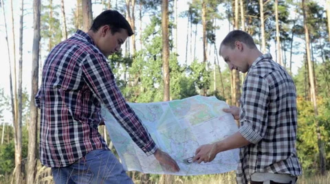 Two Tourists on a Trip, Use Map and Compass Stock Footage 68862749