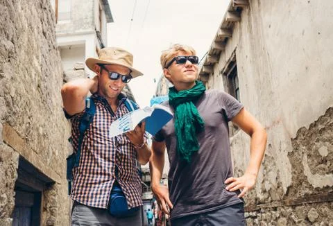 Two tourists try to navigate with guidebook on unknown asian street Stock Photos