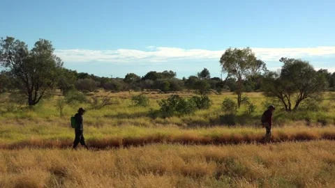 Two tourists walking through the park wearing midge nets, Australia Stock Footage 278097641
