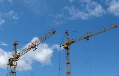 Two tower crane on sky background Stock Photos
