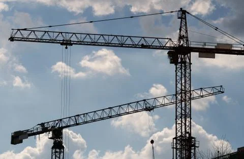 Two Tower Cranes working at constuction site. Stock Photos