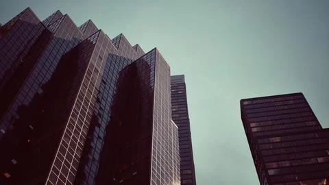 Two towering skyscrapers standing side by side in a bustling cityscape イラスト素材