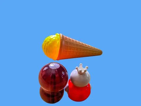Two toy figures are looking at a toy ice cream cone Stock Photos