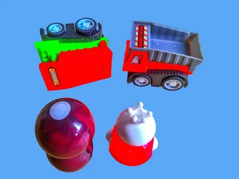 Two toy figures are looking at an overturned toy truck and a toy truck is nearby Stock Photos
