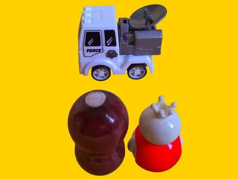 Two toy figures are looking at a toy military communication truck Stock Photos