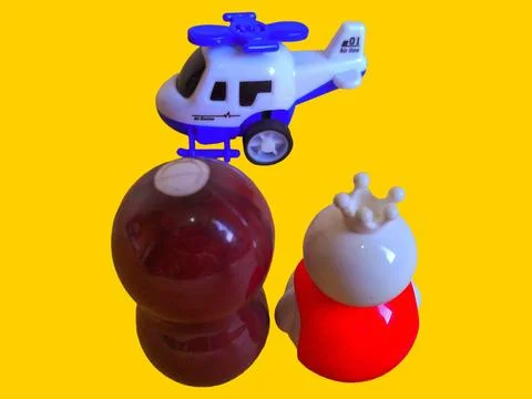 Two toy figures are looking at a toy helicopter Stock Photos