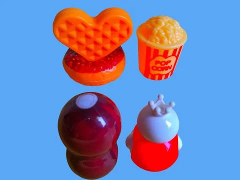 Two toy figures are looking at a variety of food toys Stock Photos