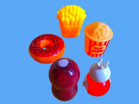 Two toy figures are looking at a variety of toy foods Stock Photos