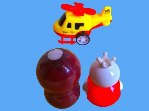 Two toy figures are looking at a toy helicopter Stock Photos