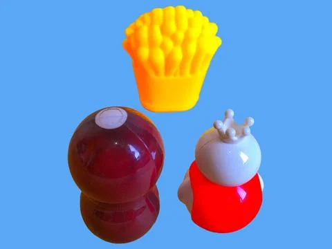 Two toy figures are looking at toy fries Stock Photos