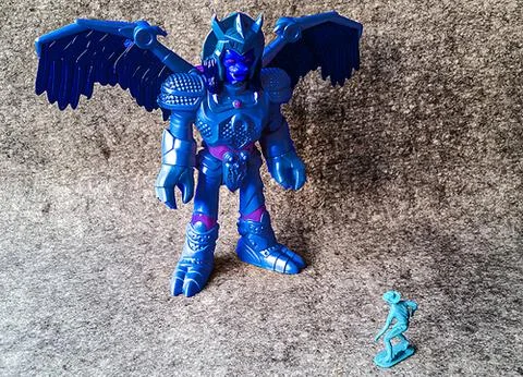 Two toy figures facing each other. One much bigger than the other Stock Photos