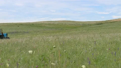 Two tractor ride out to the field to meet each other, the hay mow Stock Footage 132737344