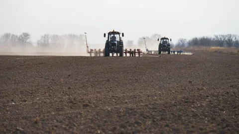 Two tractors are working in the field Stock Footage 238925632