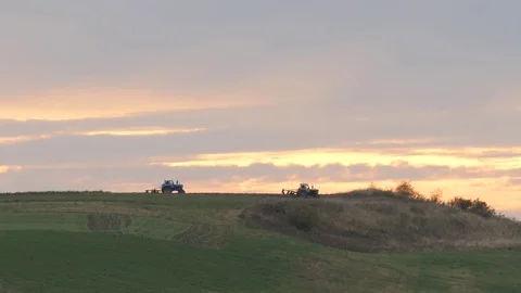 Two Tractors on Background of Sunset Open Space Beautiful Evening Landscape 動画素材 71632503