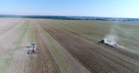 Two tractors going in the opposite direction and cultivating land with using an Video stock 123532440