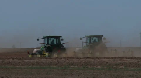 Two tractors plant side by side and meet third tractor Stock Footage 49925275
