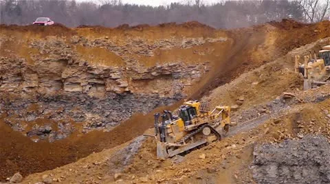 Two Tractors Pushing Dirt Down a Hill Video stock 22243480